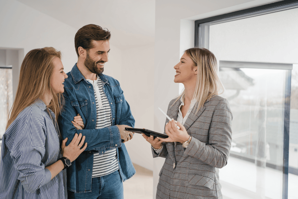 Property practitioner speaking with two clients inside a home